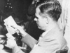 Alger Hiss examines photos of Whittaker Chambers